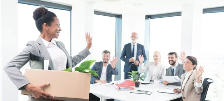 Woman waving happily goodbye to former co-workers