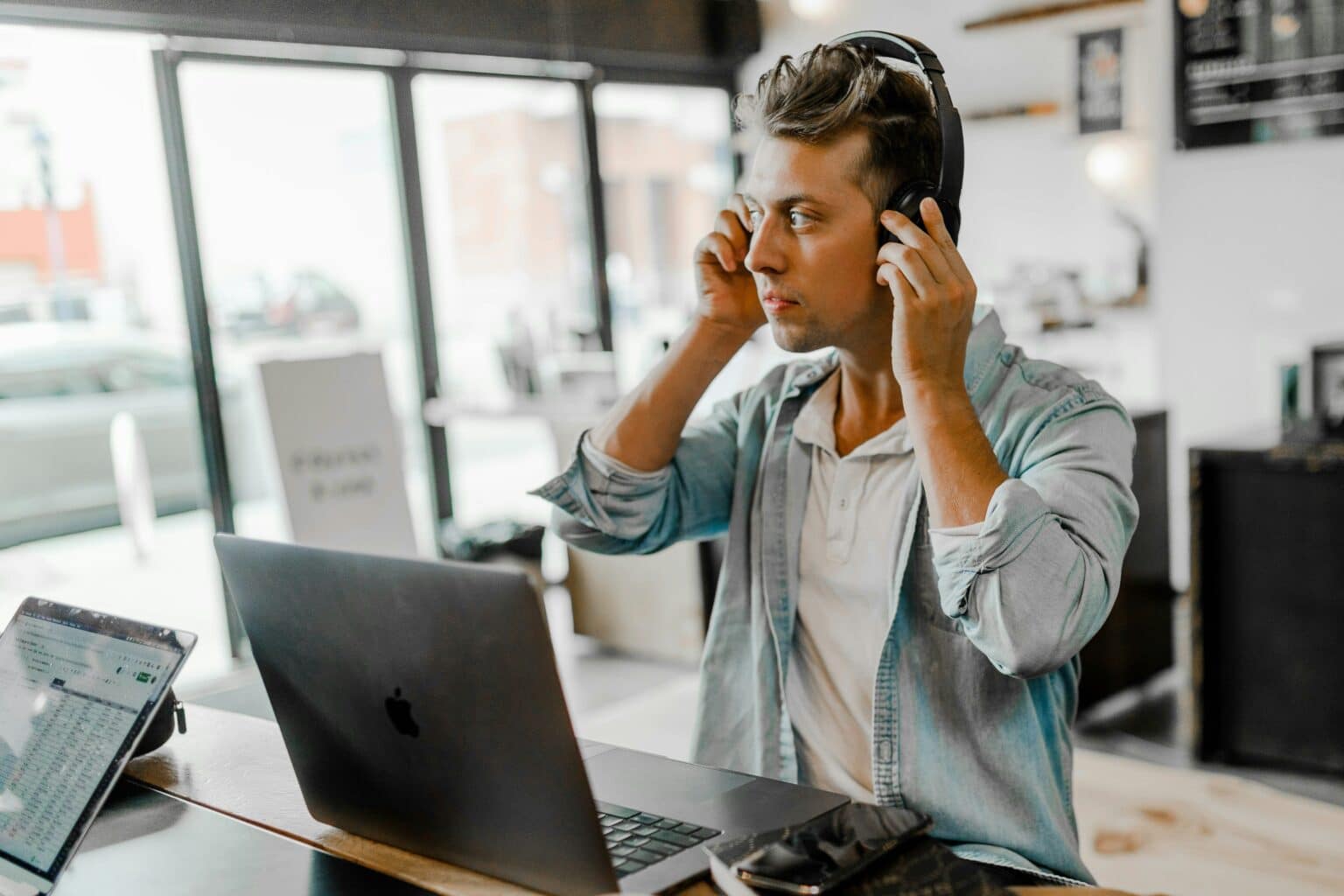 austin distel image of man working at a laptop putting on headphones